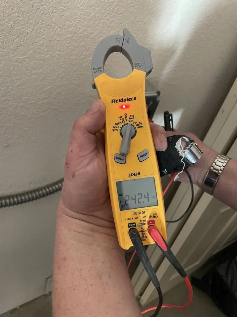 Voltage testing with clamp meter during Ceiling Fan Installation in Austin